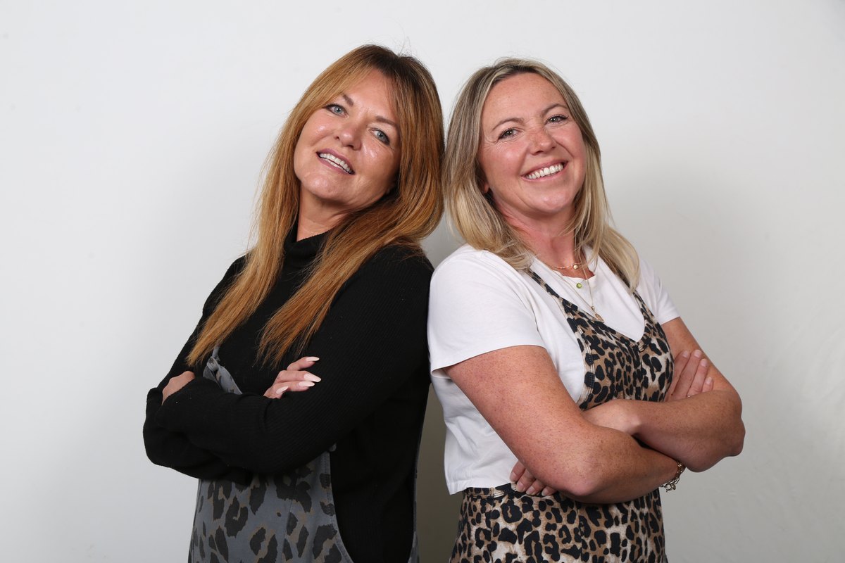 Lorraine and Claire, co-founders of Gambling Recovery Therapy, standing back to back